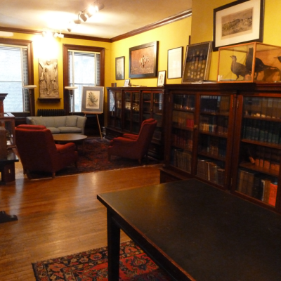 Pictures, artifacts and historic documents are displayed on the walls of the library.