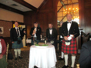 Past President James McPhee presented the Ode to the Haggis assisted by Piper Gordon Peters, Armourer James Burns and Past President Richard Hixon
